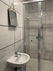 a white bathroom with a sink and a shower at The Botley Road House in Oxford