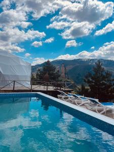 a swimming pool with a view of mountains at Paradise Inn in Batumi
