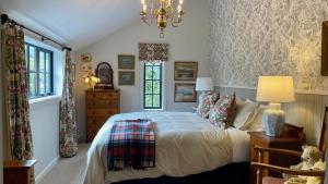 a bedroom with a bed and a chandelier at The Barn at Killin B&B in Ohau
