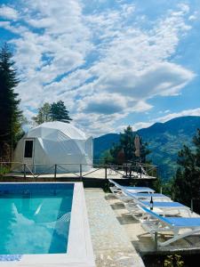 a resort with a swimming pool and a tent at Paradise Inn in Batumi