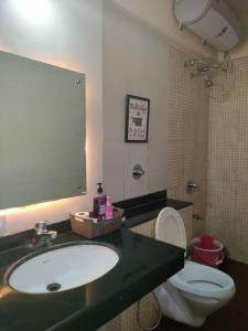 a bathroom with a sink and a toilet at Portofino TreeHouse in Lavasa