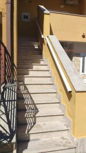 a stairway leading up to a building with a shadow at Villaggio al mare in Manfredonia