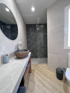 a bathroom with a stone sink and a shower at La Villa de Jaén - Catedral in Jaén