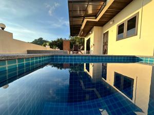 ein Pool mit blauen Fliesen in einem Haus in der Unterkunft KohTao Studios Sunset in Ko Tao