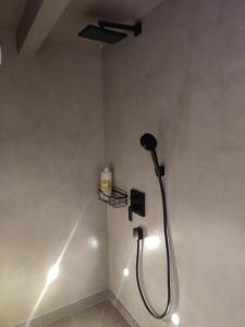 a shower in a bathroom with lights on the wall at Chambres et tables d'hôtes Cornec in Ploubazlanec