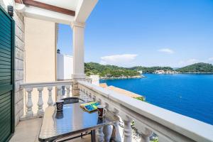 a balcony with a table and a view of the water at Lovely studio apartment in Sobra