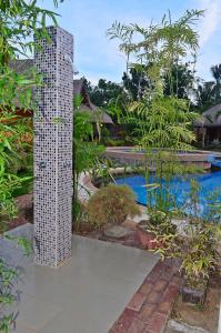 a tall white building next to a swimming pool at Veraneante Resort in Panglao Island