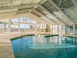 a large swimming pool in a building with a pool at Beach Colony Towers #2B - Villa Monarch in Perdido Key