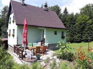 a house with a patio with a table and chairs at Chata Lipno in Lipno nad Vltavou