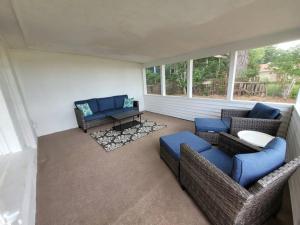a living room with two couches and a table at Waterfront Cottage near Lambeau and Door County! in Green Bay