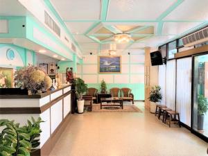 a lobby with a waiting area with a table and chairs at Inn Sun Hotel in Changhua City