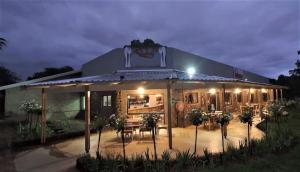 a building with a table and chairs in front of it at Lodge Laske Nakke in Lydenburg