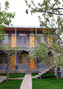 a building with a staircase in front of it at Andranik B&B in Goris