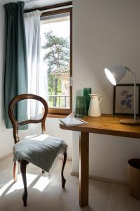 a wooden desk with a chair and a window at Cascina Bagaggera in Rovagnate