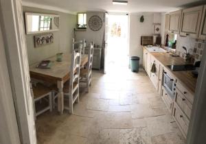 a kitchen with a table and a counter top at bastide saint georges in Fayence