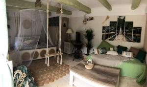 a bedroom with a swing in a room at bastide saint georges in Fayence