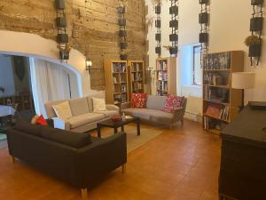 a living room with two couches and a table at Casa Pereirinha \ Pateo House in Vidigueira