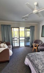 a bedroom with two beds and a ceiling fan at Bramston beach resort in Bramston Beach