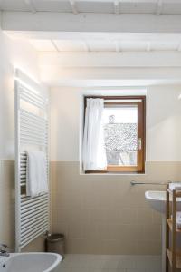 a bathroom with a sink and a window at Cascina Bagaggera in Rovagnate