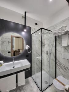 a bathroom with a shower and a sink and a toilet at Hotel Maiuri Pompei in Pompei