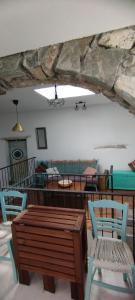 un soggiorno con panca e sedie in legno di The Village House a Kerames