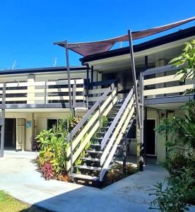a building with a staircase in front of it at Bramston beach resort in Bramston Beach