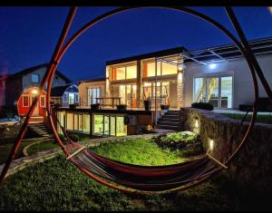 a house with a hammock in front of it at Villa Lyra in Trebinje