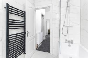 a white bathroom with a shower and a sink at Host Liverpool - Elegant Anfield Getaway in Liverpool