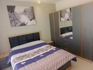 a bedroom with a bed and some cabinets and a mirror at Lagoon View 2 Bedroom IL Monte Galala Ain Sokhna C2-CH28-2-1 in Ain Sokhna +21 photos