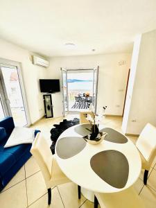 a living room with a table and a blue couch at Apartments Imperium in Trogir