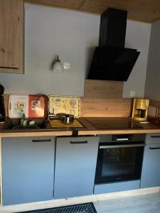 a small kitchen with a sink and a stove at entre vignes et montagnes chambres in Fréland