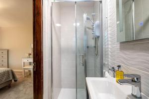 a bathroom with a shower and a sink at Naughtons Villa in Killarney +41 photos