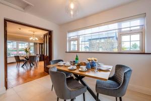 a dining room with a wooden table and chairs at Naughtons Villa in Killarney