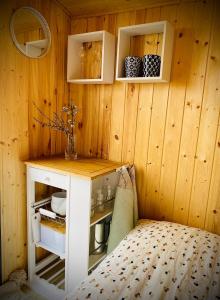 a room with a wooden wall with a counter and a table at Maringotka Za Trnkou 