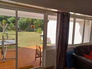 a room with sliding glass doors with a view of a yard at Mouragolf 3 bedroom townhouse in Vilamoura