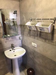 a bathroom with a sink and a mirror at Nigatun Hotel in Yerevan