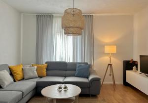 a living room with a couch and a table at Holiday Apartments Soparin in Senj