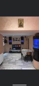 a living room with a table and a flat screen tv at Casa Yachi Vama Veche in Vama Veche