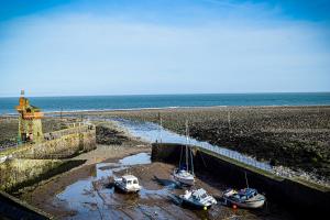 a group of boats docked on the beach at Rising Sun Hotel in Lynmouth