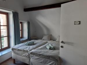 a bedroom with a bed with two pillows on it at Het Maelslot (Mechelen) in Mechelen