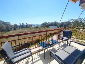 two chairs and a table on the balcony of a house at Sea & Sun - 4th floor comfy apartment, great view in Preveza
