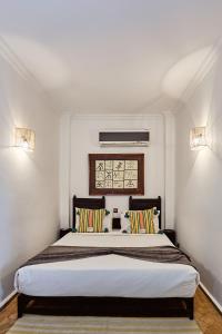 a bedroom with a large bed with two pillows at Riad Eldar in Marrakesh