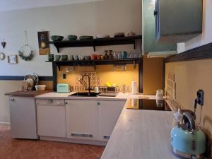 a kitchen with a stove and a counter top at ART HOME - mieszkanie 83m, 500m od Morza, Podczele, Kołobrzeg in Kołobrzeg