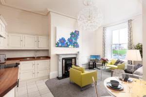 a kitchen and living room with a fireplace at Royal Discovery in Whitby