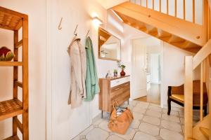 a small hallway with a staircase and a sink in a house at Ferienhaus 1 Fuchsweg in Stralsund