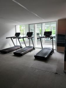 a room with three treadmill desks and a room with windows at Ocean Drive Country, Punta del Este - 2 amb de lujo in Punta del Este
