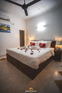 a bedroom with a large bed with roses on it at Bright Waves Villa in Bentota