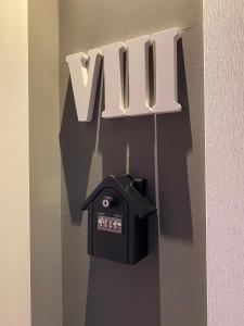 a sign with the word vim hanging on a wall at Hotel Boutique Teatro Romano in Málaga