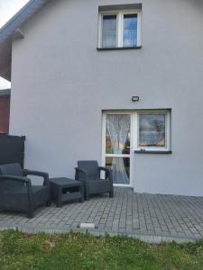 Mörken的住宿－Dom Wiśniowy Zakątek，一个带两把椅子和窗户的庭院