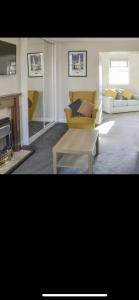 a living room with a couch and a coffee table at Village view apartments in Tynemouth